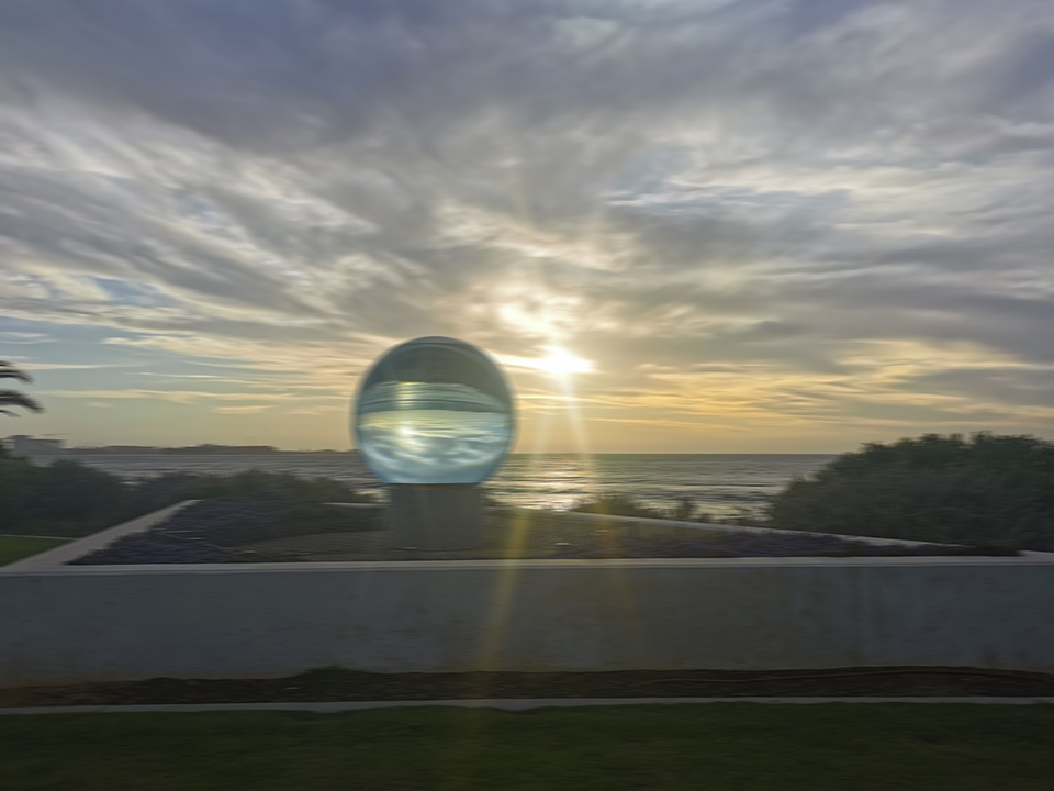 The big Marble at Sunset reflecting colors of nature - cloud, sea, greens