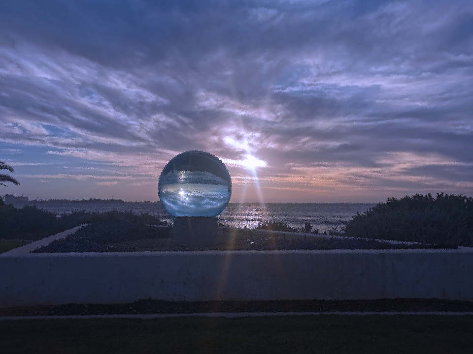 The big Marble at Sunset reflecting colors of nature - cloud, sea, greens