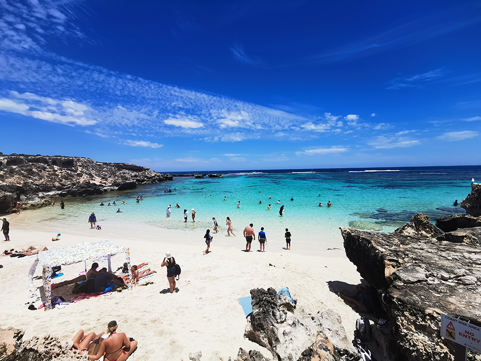 Lots of people in Rottnest island enjoy sunshine and colorful sea or stand on the sandy beaches